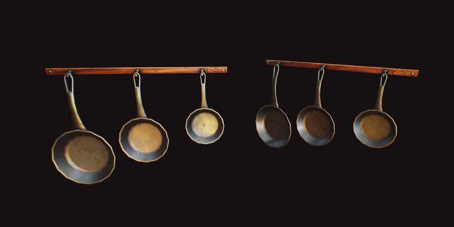 Copper pans hanging from a wooden rail